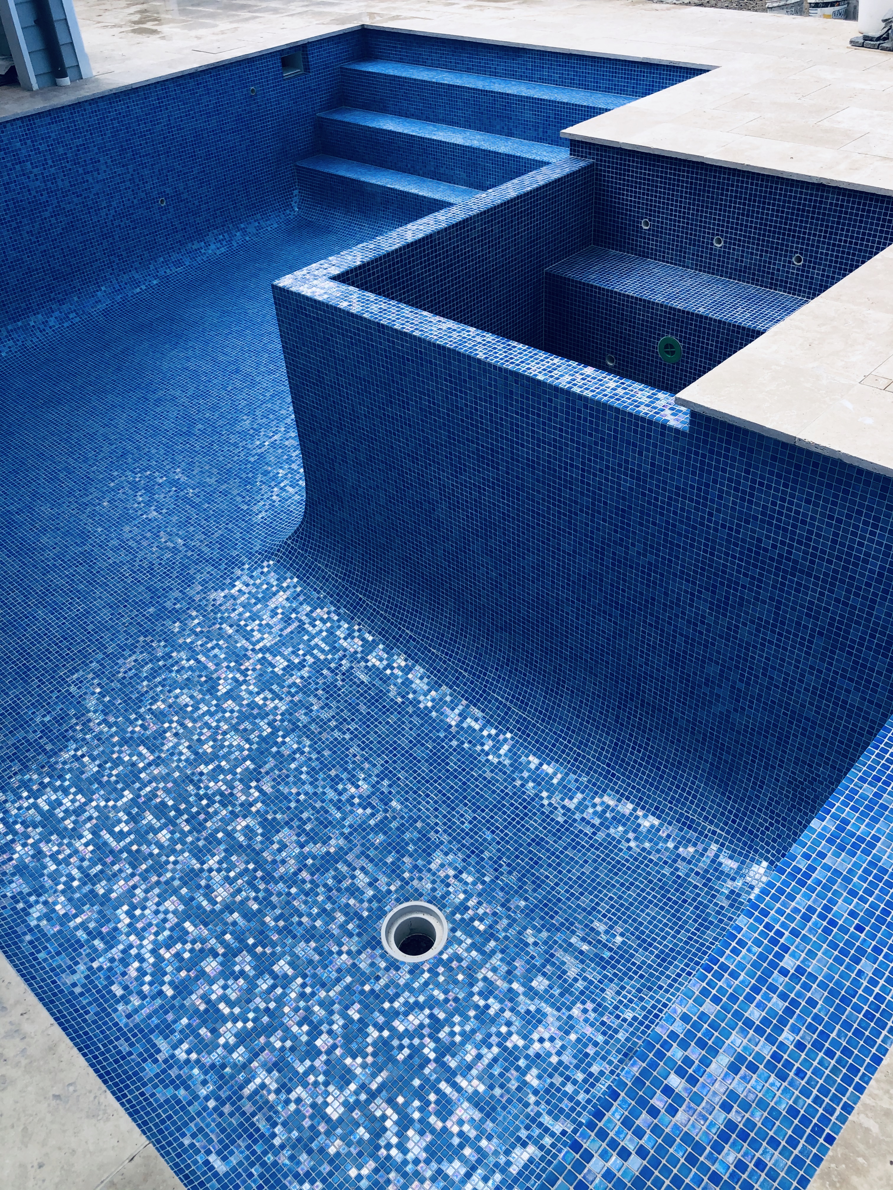 Fully tiled swimming pool with premium mosaic tiles installed by Quasar Pools, Sydney’s experts in pool tiling and renovations.