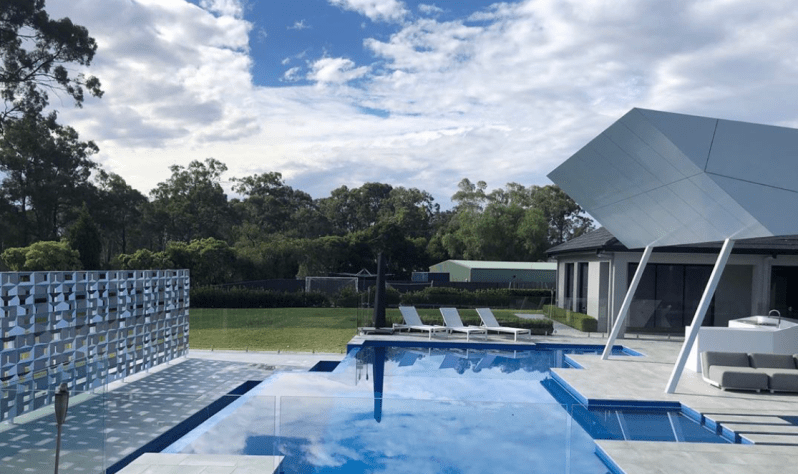 Modern fully tiled infinity pool featuring glass mosaic tiles and premium pool waterproofing solutions in Sydney.